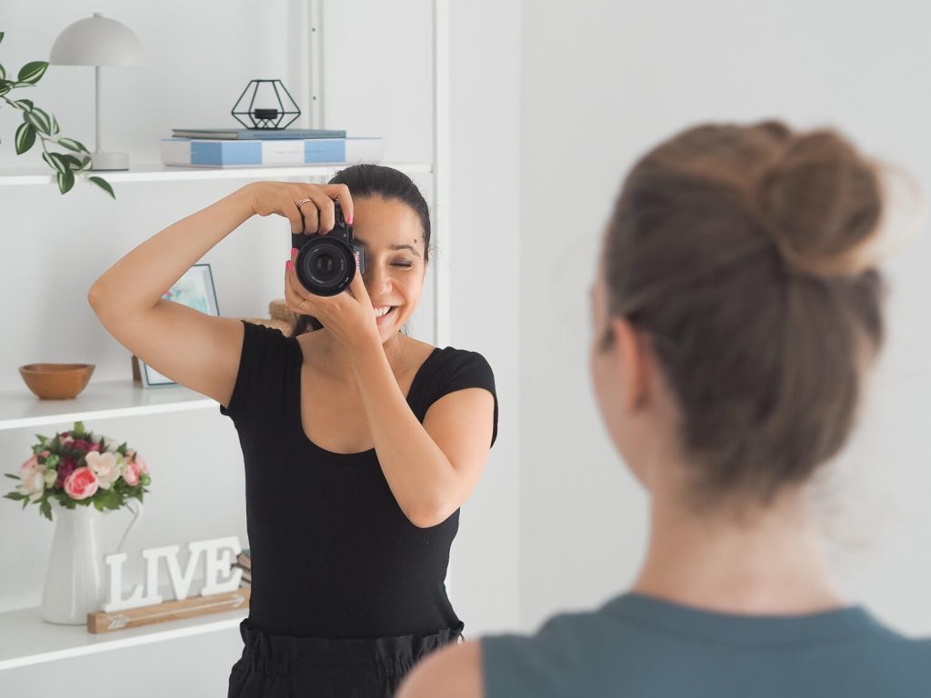 Fotós nő fényképez, előtérben a modellje – brand fotográfus fotózása
